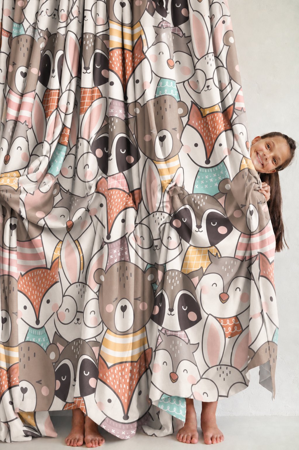Woodland animal curtain beside a dresser in a child's room