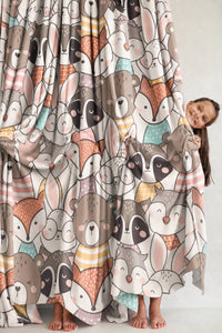 Woodland animal curtain beside a dresser in a child's room