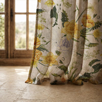 Hem of a yellow daffodil curtain resting on a stone floor